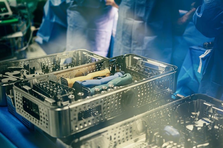 Surgical instruments in metal perforated trays during medical sterilization process with blue lighting